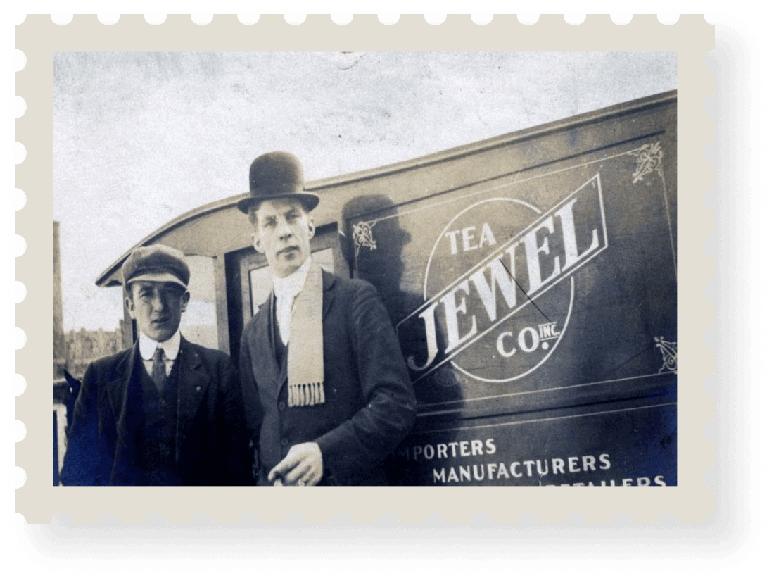 Two men standing near Jewel Tea truck