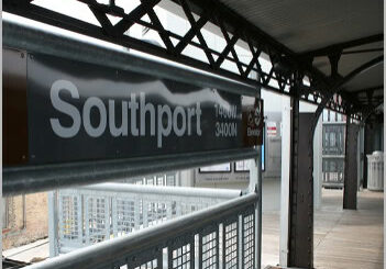 Event-2 Southport station platform, metal railing and signage.